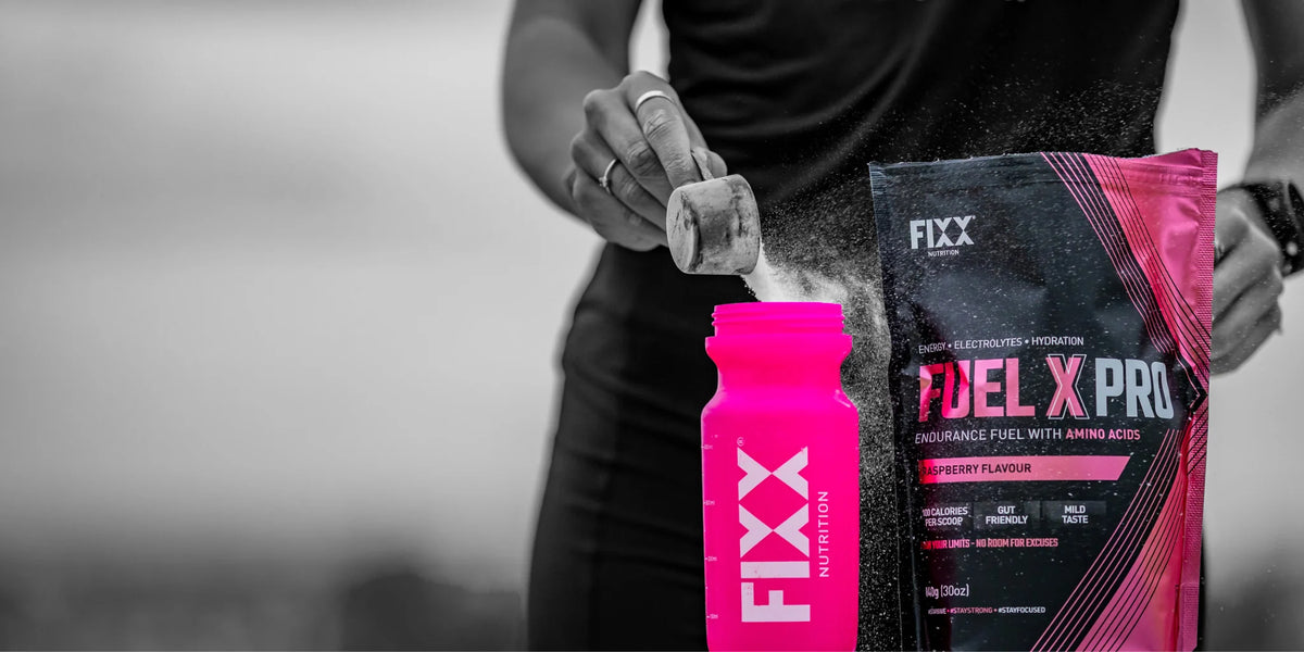 Runner holding a Fixx Nutrition Fuel X Pro pouch and drink bottle