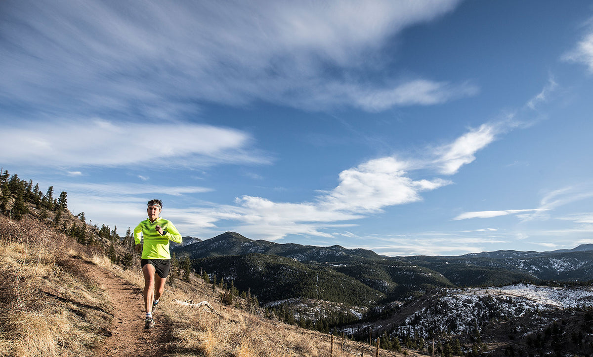 Trail runner on a sunny mountain trail
