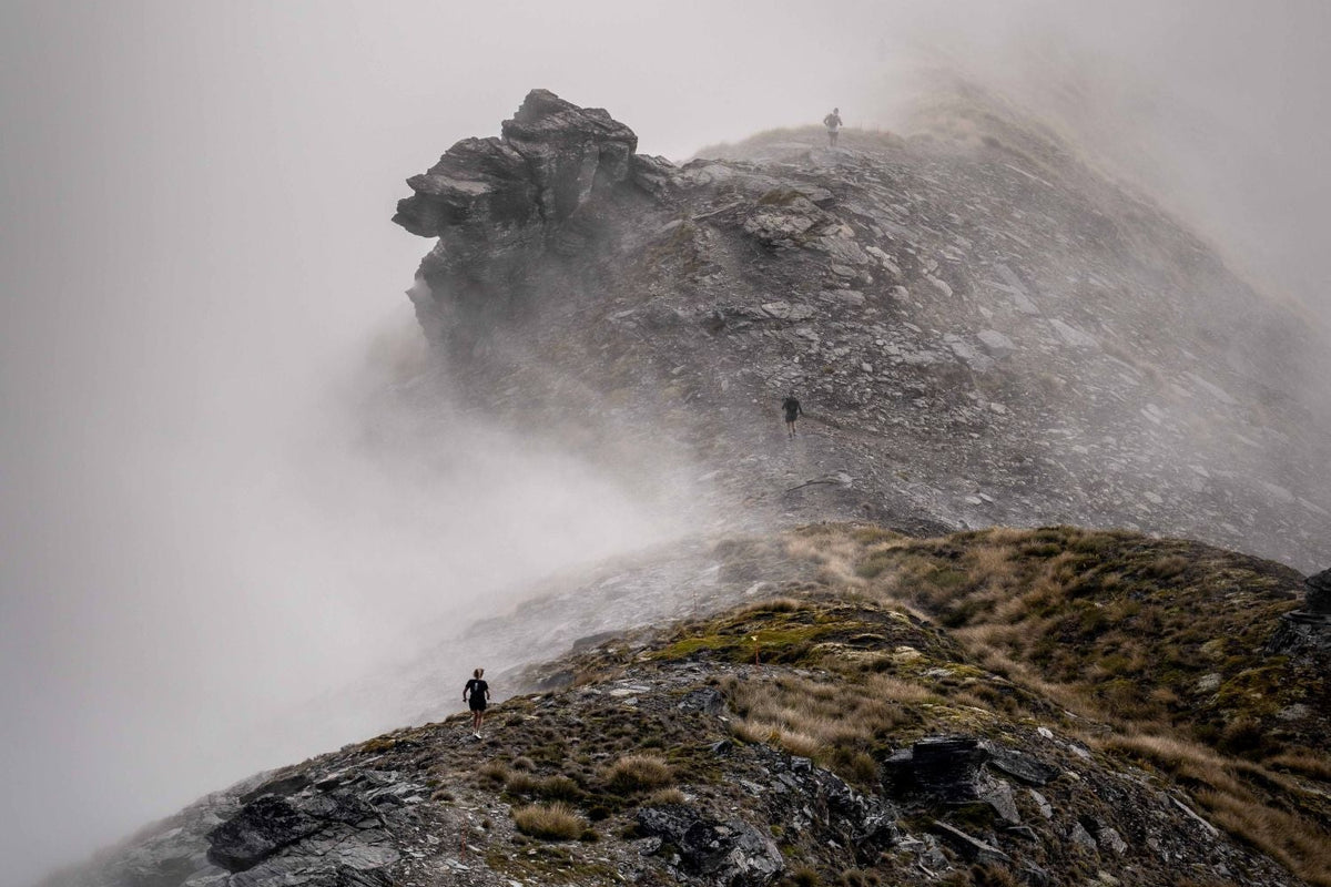 Runner on a misty, rocky mountain ridge