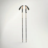Pair of Black Diamond Trail Vista FLZ trekking poles in White/Oak, standing upright with cork grips and wrist straps