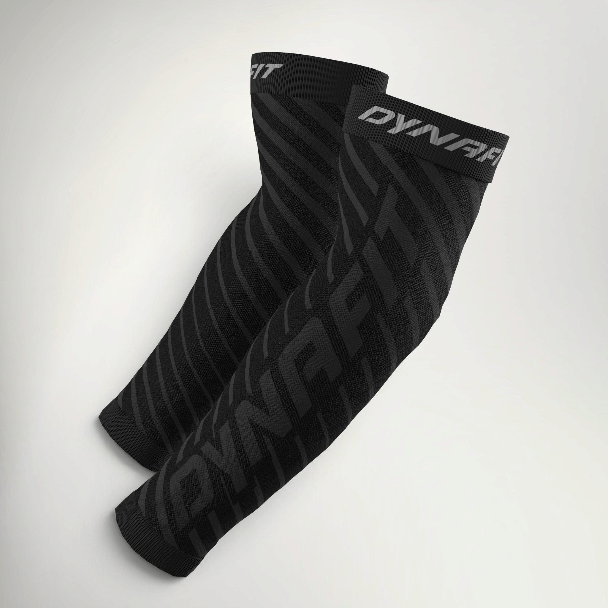 Pair of Dynafit Performance Arm Guards in black with tonal diagonal Dynafit logo print and grey branded cuffs