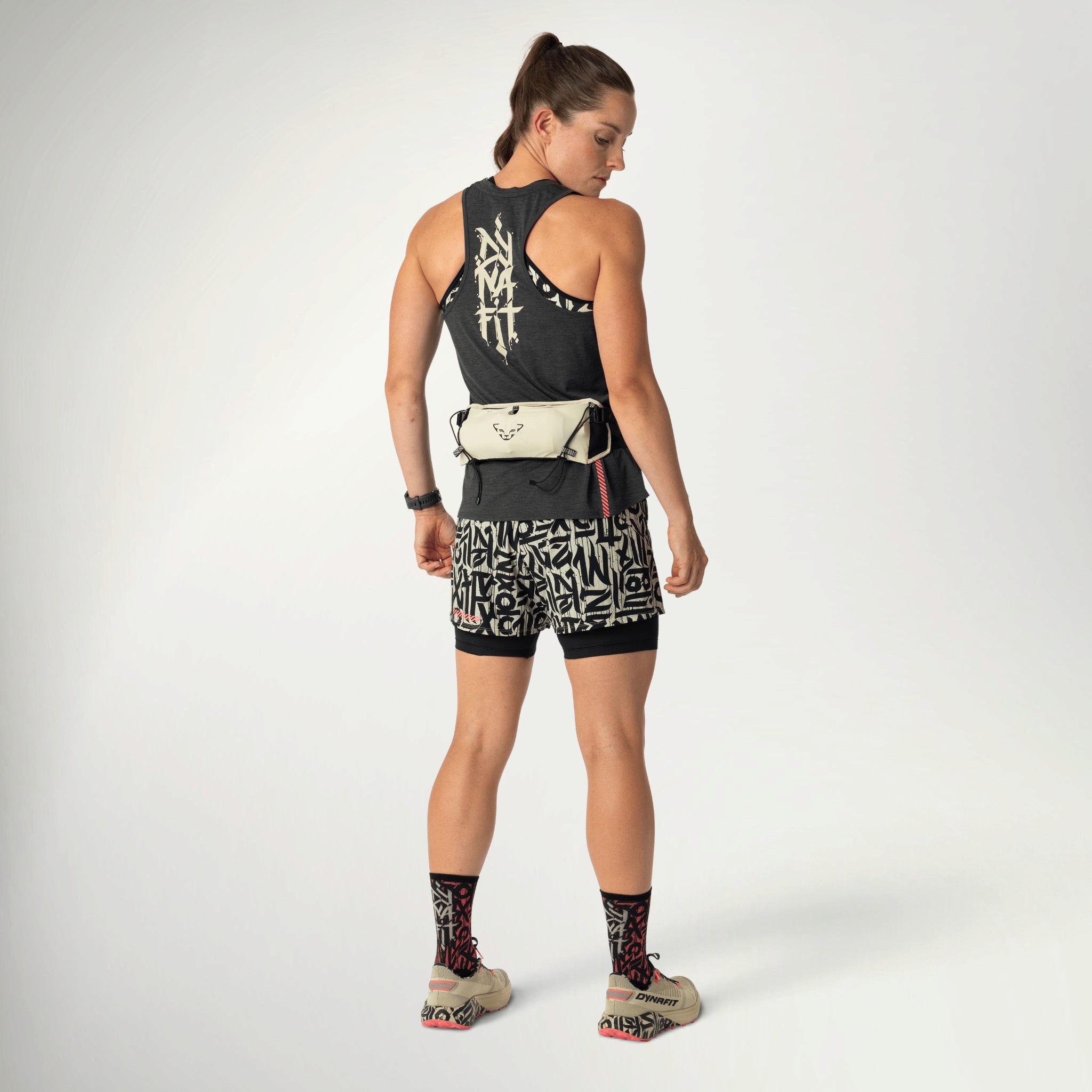 Dynafit Trail Belt in Overcast worn by a runner, full-length back view