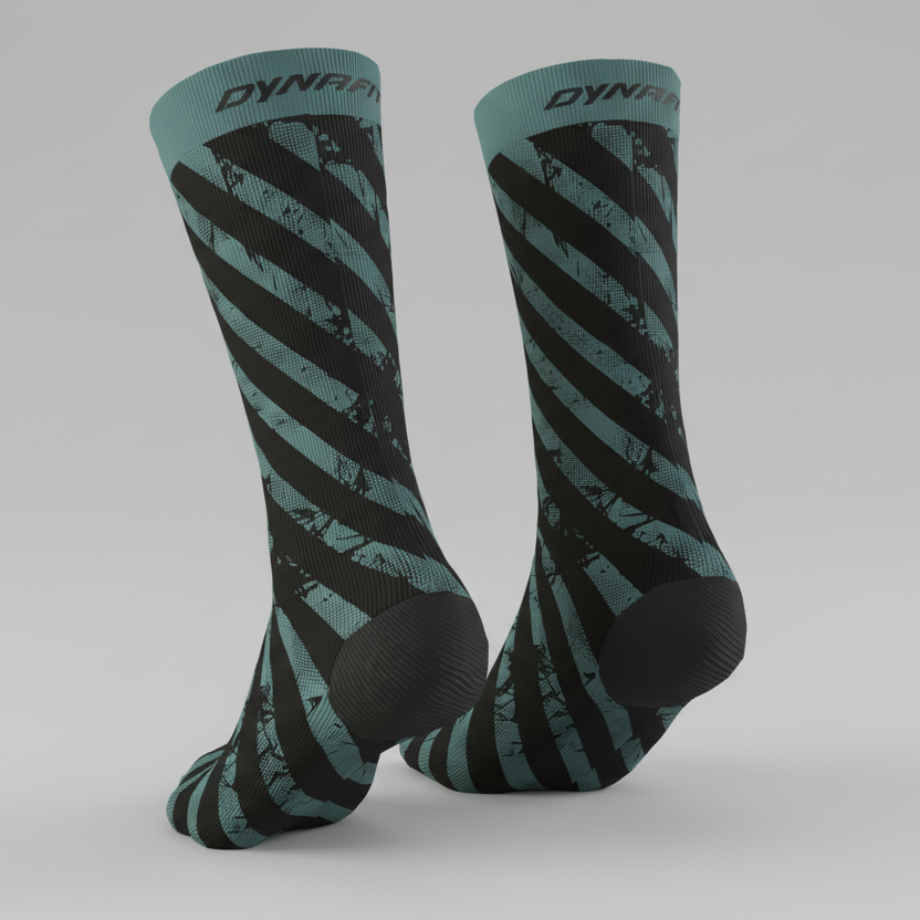 Pair of Dynafit Trail crew running socks in Atlantic, teal and black diagonal stripes with Dynafit logo on the cuff