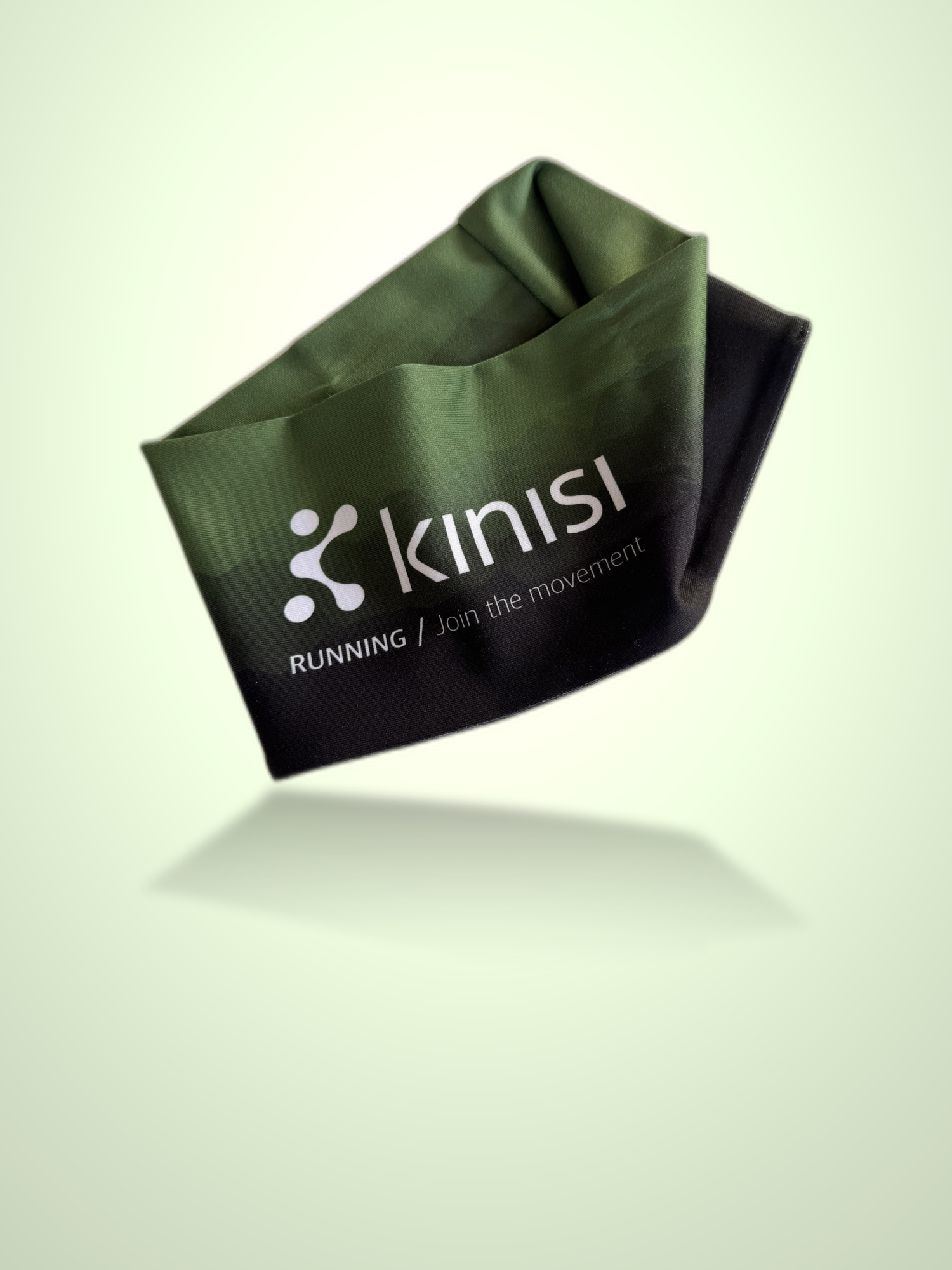 A dark green and black fabric running headband with the Kinisi logo and 'RUNNING / Join the movement' printed on it, shown floating against a pale green gradient background.