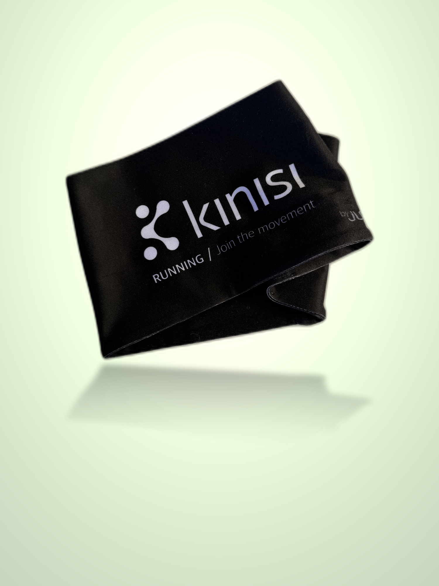 A black fabric running headband with the Kinisi logo and 'RUNNING / join the movement.' printed in white, shown floating against a pale green gradient background.