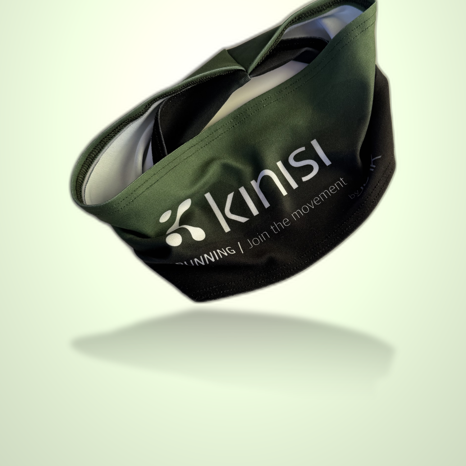 An olive green and black Kinisi Running headband floating against a light green gradient background with a soft reflection underneath.