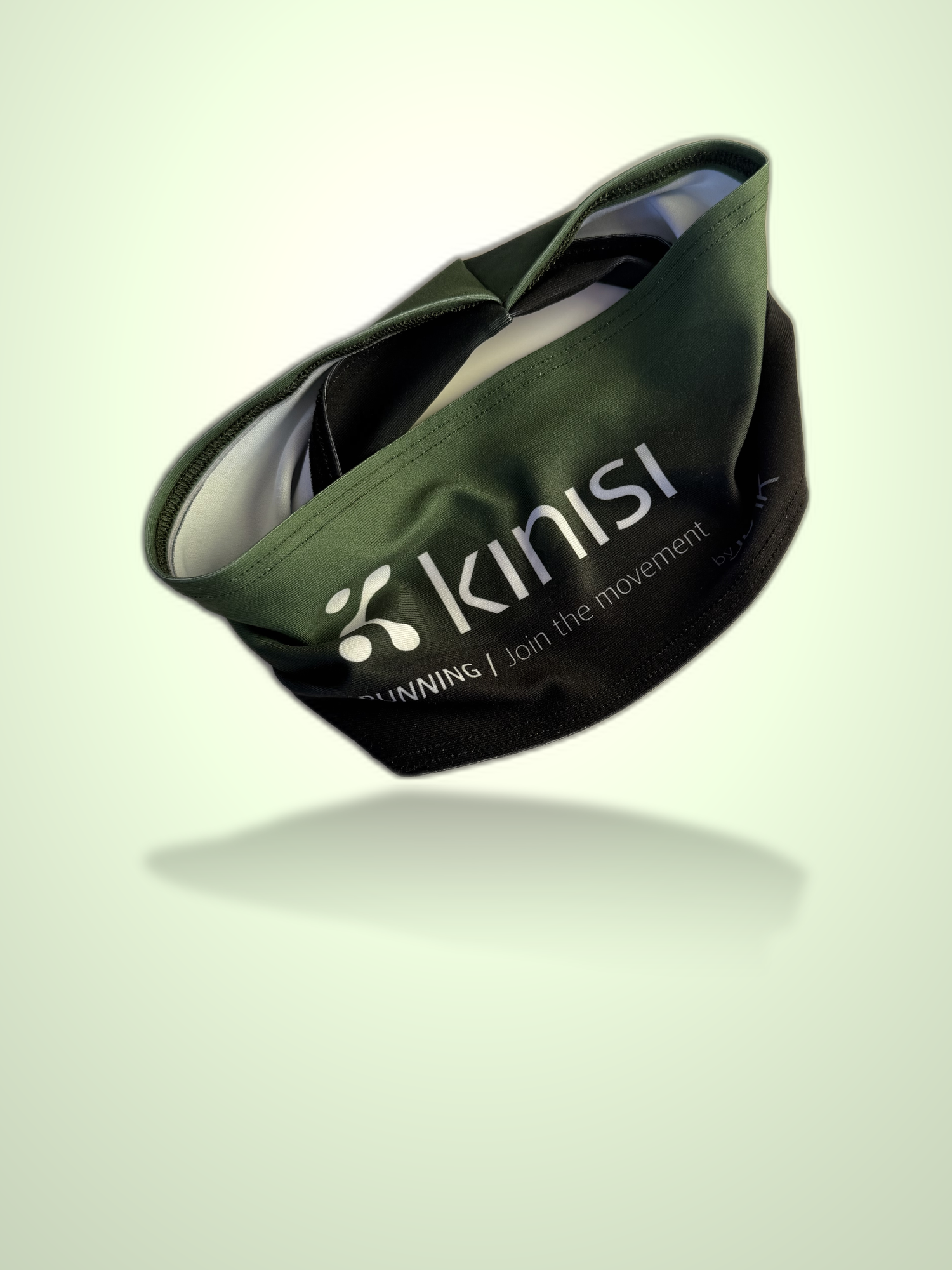 An olive green and black Kinisi Running headband floating against a light green gradient background with a soft reflection underneath.