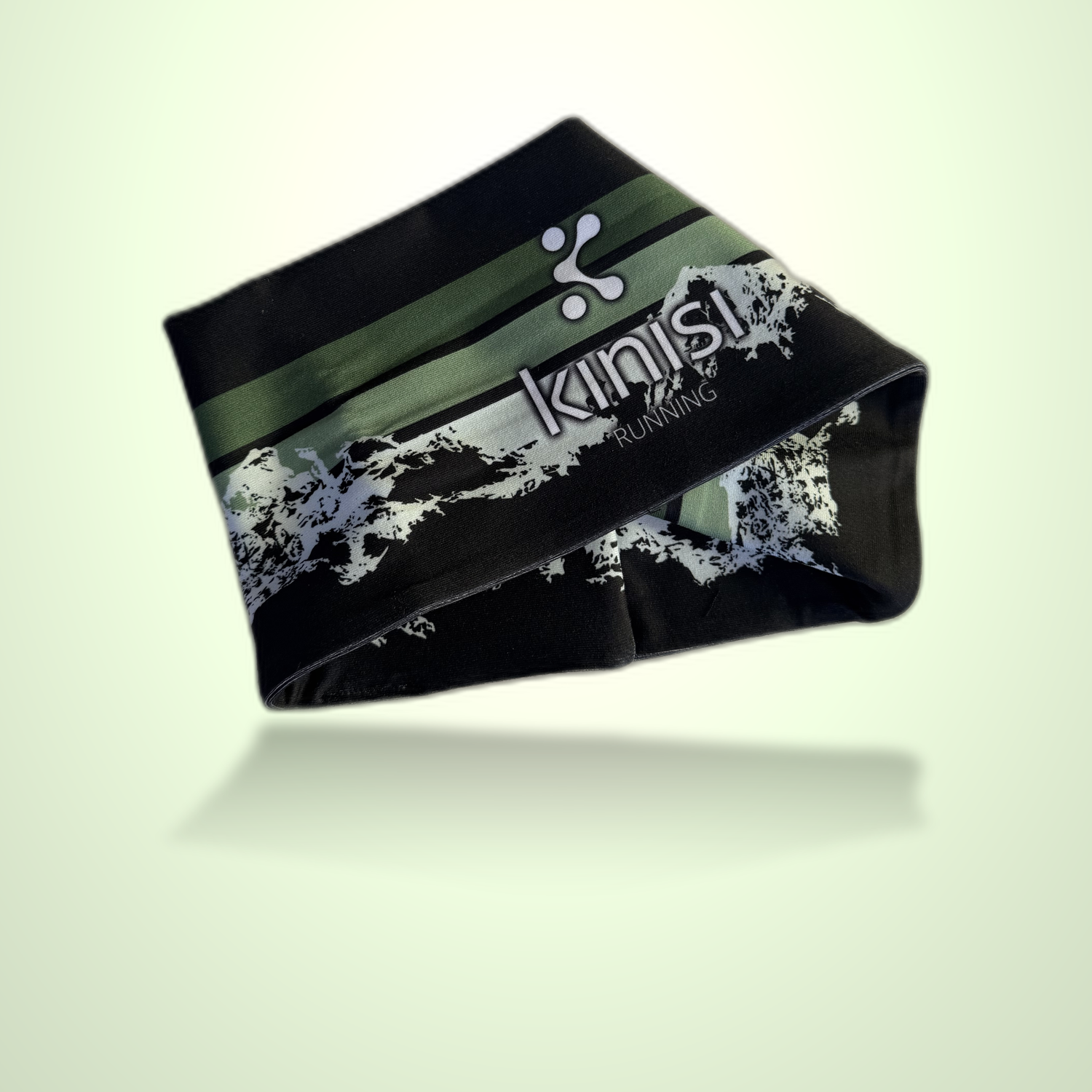 A black athletic headband with green and white graphic stripes and the brand name 'kinisi Running' printed on it, shown floating against a pale green gradient background.