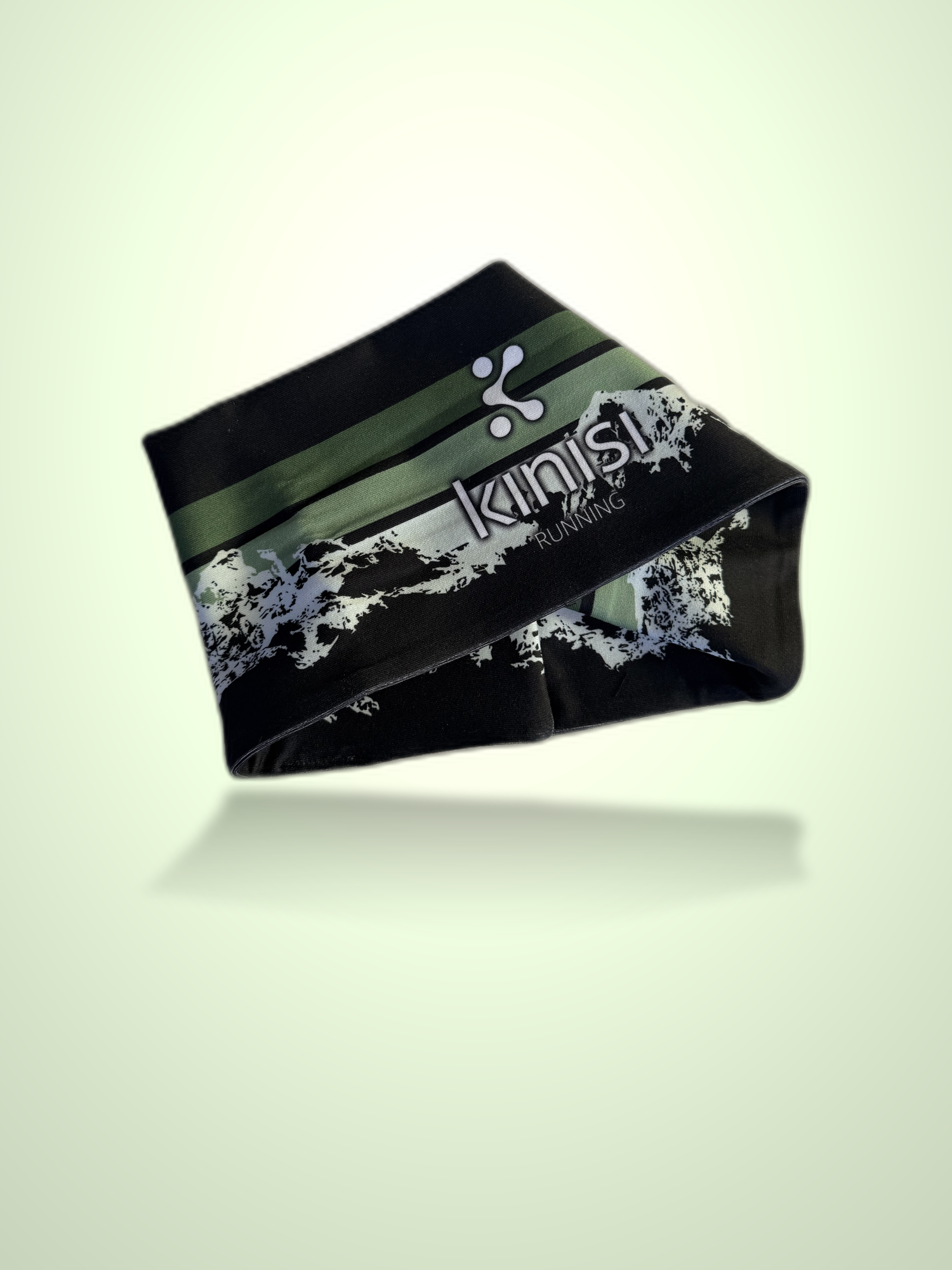 A black athletic headband with green and white graphic stripes and the brand name 'kinisi Running' printed on it, shown floating against a pale green gradient background.