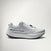 A light gray and white Mount to Coast running shoe shown from the side against a clean, light gray studio background.