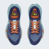 A pair of The North Face running shoes shown from a top-down view on a light gray background. The shoes feature a navy blue mesh upper with bright orange laces, orange accents on the midsole, and a light teal/blue-green outer sole.