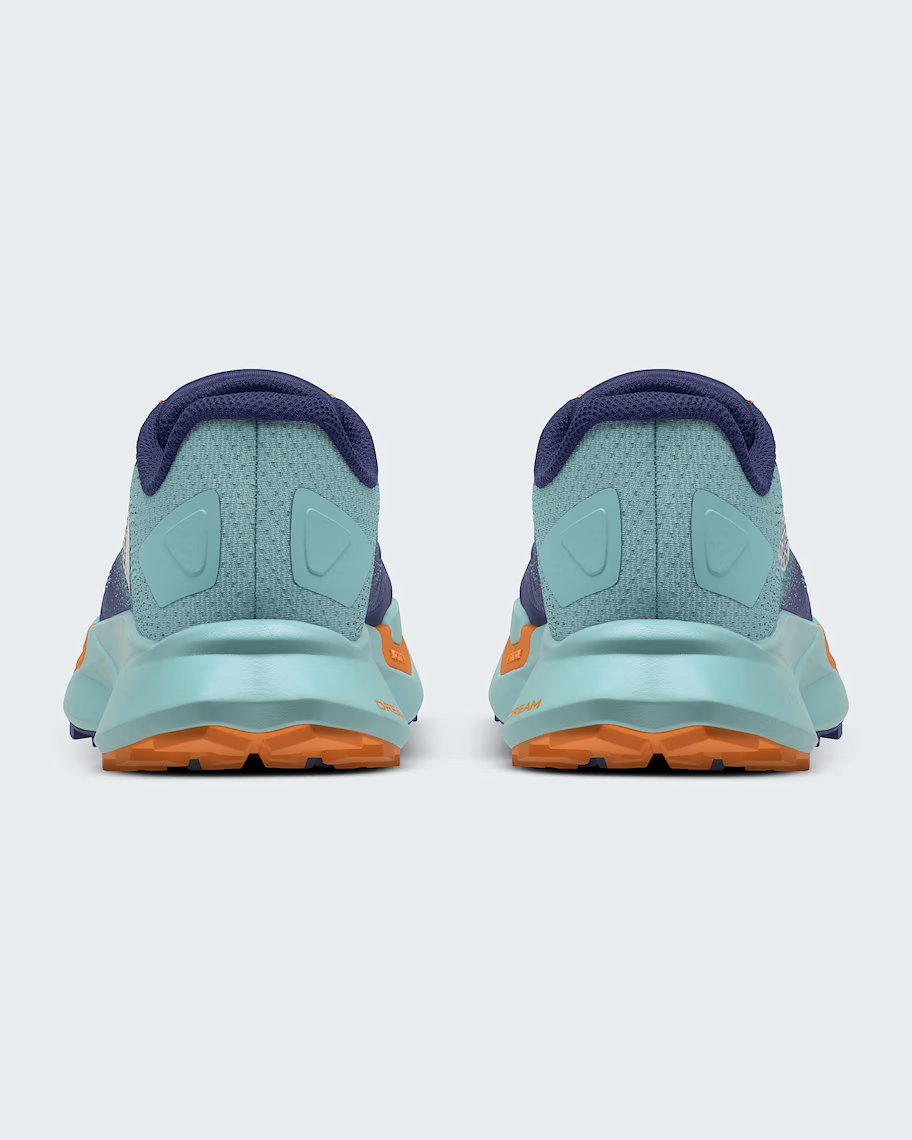 Rear view of a pair of The North Face athletic sneakers in light teal, dark purple, and orange, shown against a light gray background.