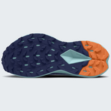 The outsole of a The North Face trail running shoe shown from a top-down view, featuring a dark navy blue tread with a light blue geometric accent and a bright orange rear section.