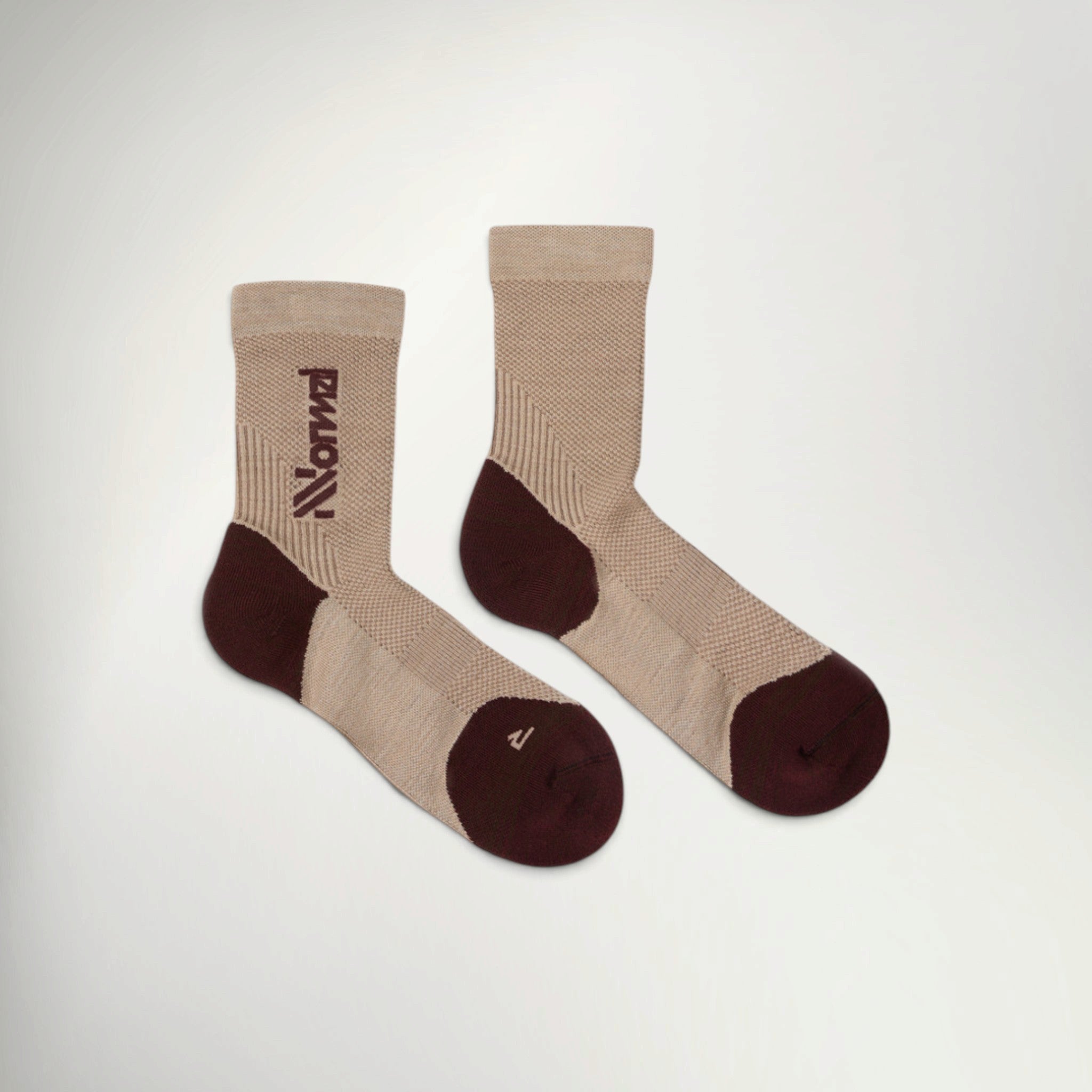 Pair of NNormal Merino crew running socks in Beige with burgundy heel, toe and NNormal logo