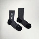 Pair of NNormal Merino Sock 02 crew running socks in Black, charcoal grey with black heel, toe and white NNormal logo