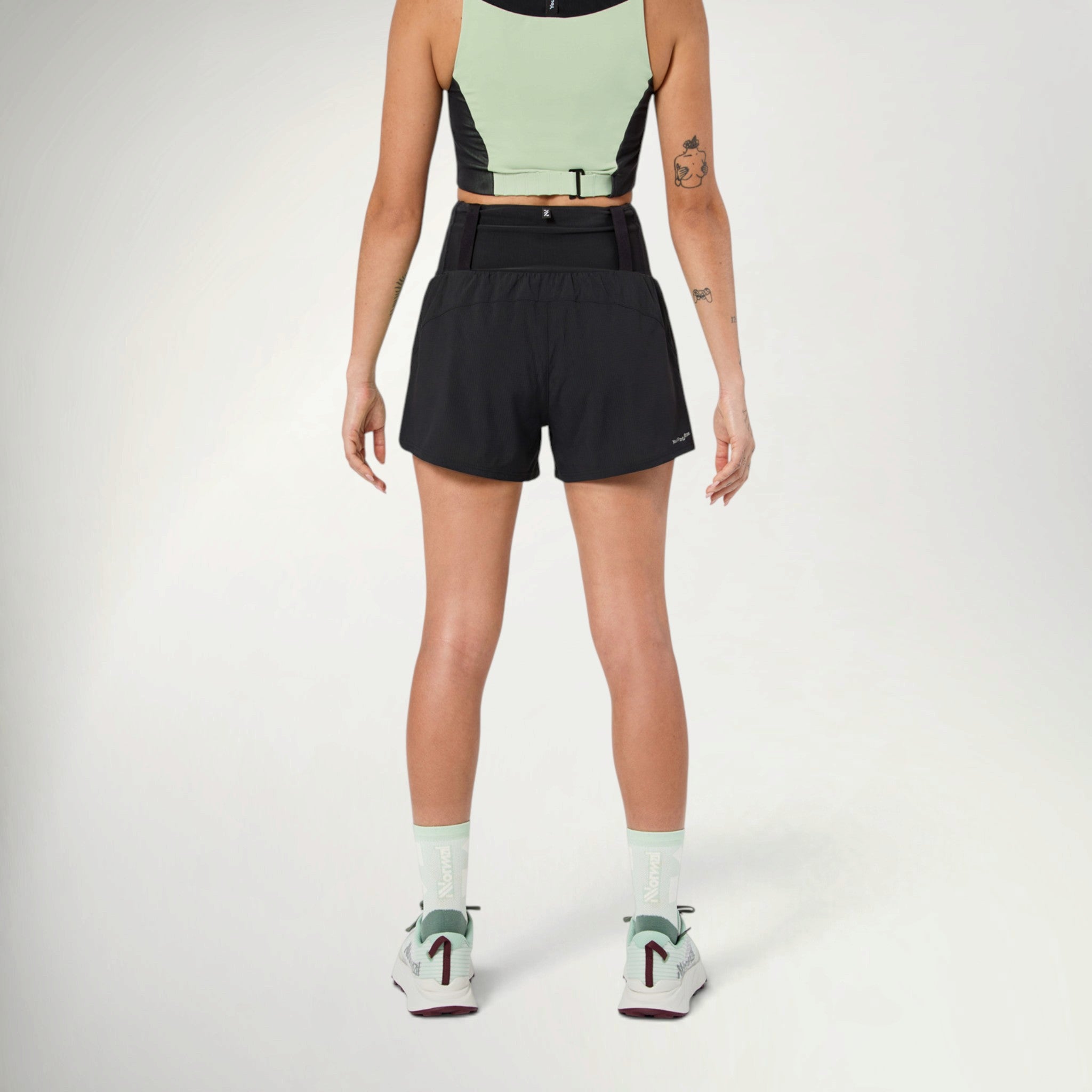 NNormal Race Shorts Women's in Black worn by a runner, close-up front view