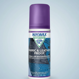 A bottle of Nikwax Waterproofing Fabric & Leather Proof spray-on waterproofer, featuring a purple cap and a blue and white label, set against a plain white background.