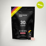 A black stand-up pouch of Precision Fuel 30g carb chews in Watermelon flavor, shown on a light gray background with a small pink chew and a green 'NEW!' badge.
