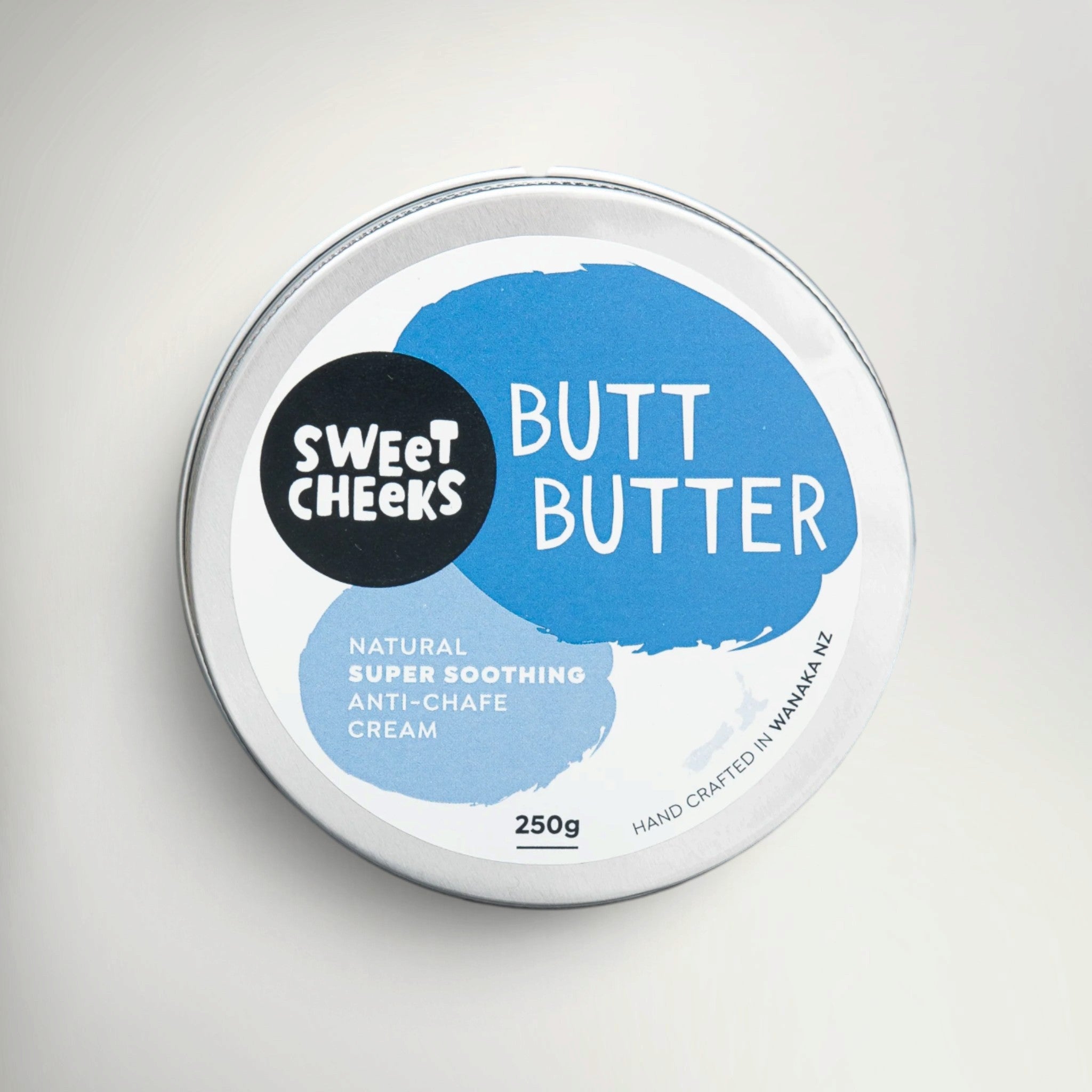 Sweet Cheeks Butt Butter 250g tin of anti-chafe cream, top view of the blue and white lid