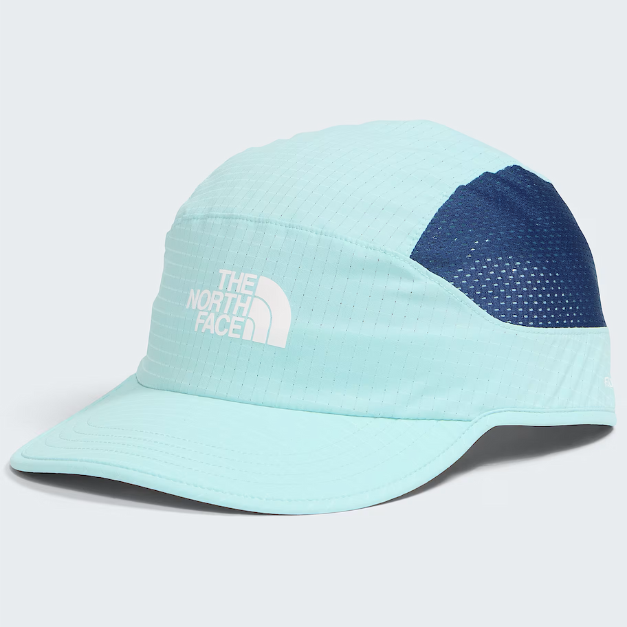 A light blue and navy blue performance cap by The North Face, featuring a white embroidered logo on the front panel, set against a light gray background.
