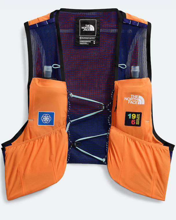 The North Face running vest with orange side pockets and a navy mesh back, shown flat on a white background.