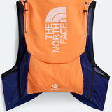 The North Face running vest shown from the back, featuring a bright orange back panel with a large white logo, navy blue mesh side panels, and black trim.