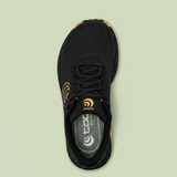 Black Topo running shoe with orange accents on a white background