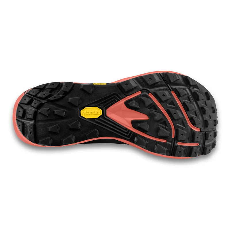 Close-up of a shoe sole with black and rose design on a white background
