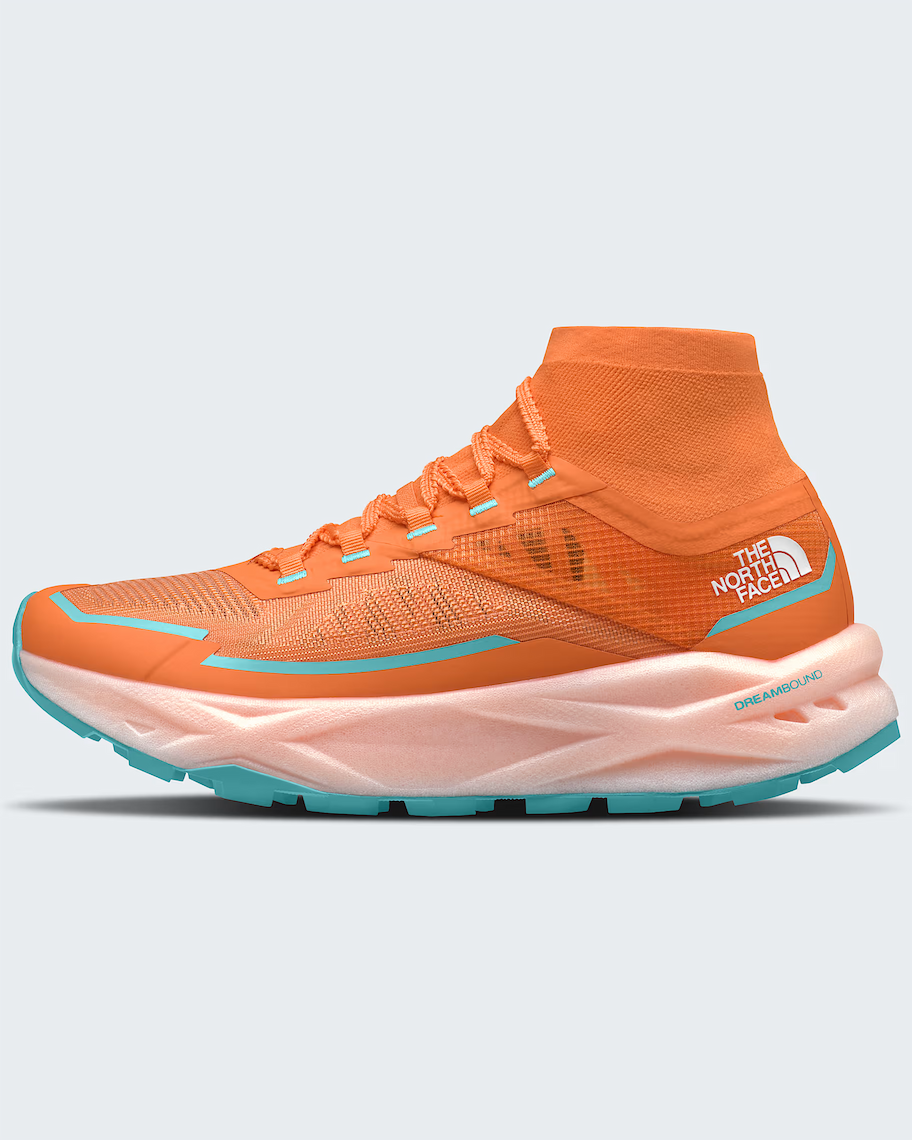A single The North Face sneaker in bright orange with turquoise accents and a pale pink midsole, shown from the side against a light gray background.